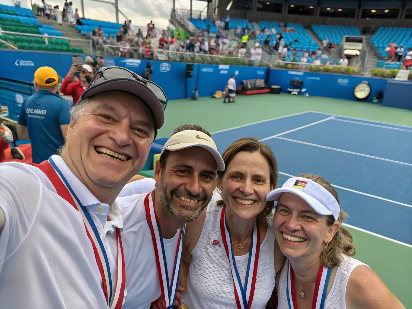 An image showing members of the tennis club participating in a community event, such as a charity tournament or a local festival. The players are interacting with community members and promoting the sport of tennis.